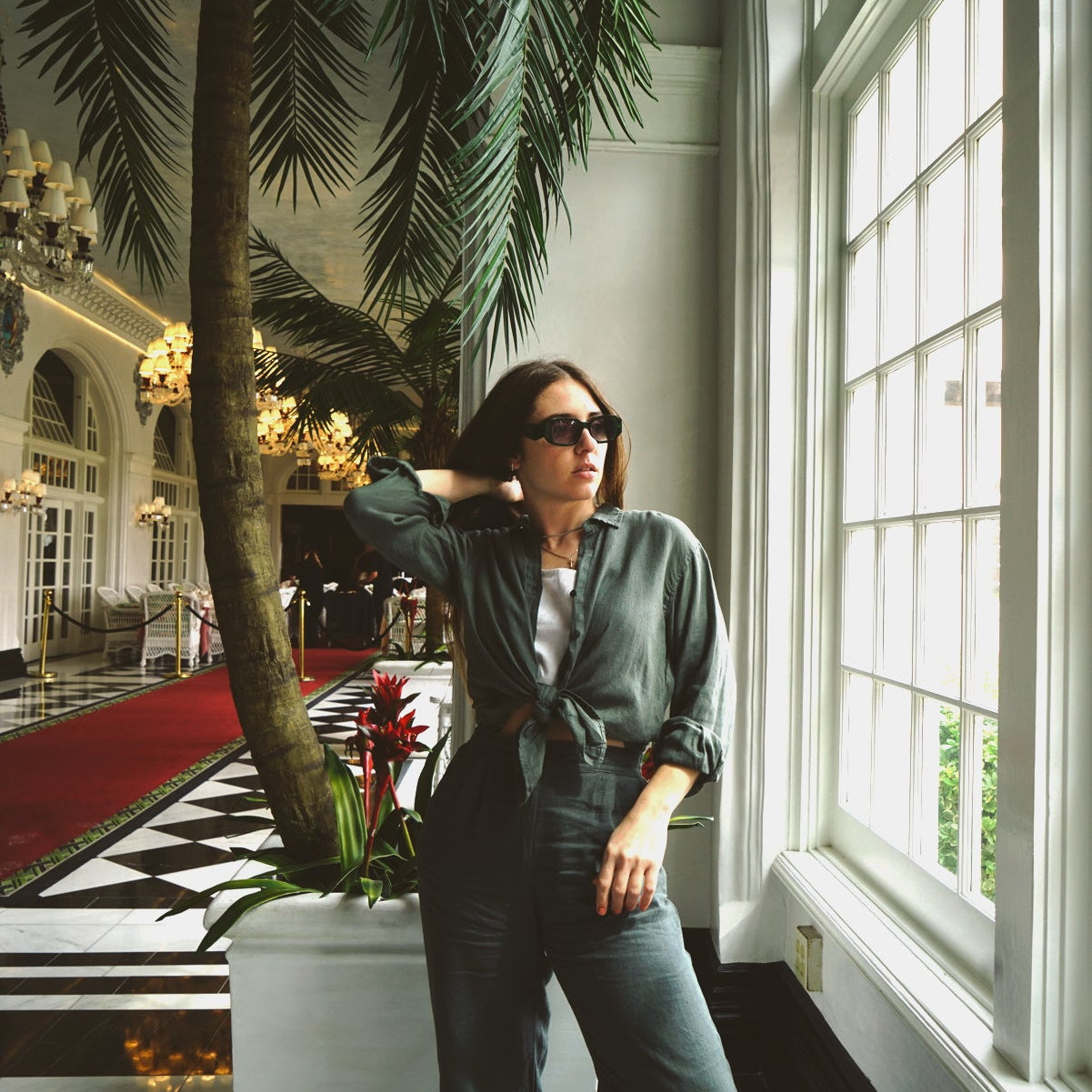 Green linen top and pants in hotel lobby